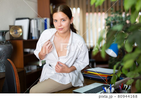 Attractive secretary posing in office Attractive secretary posing in office 80944168