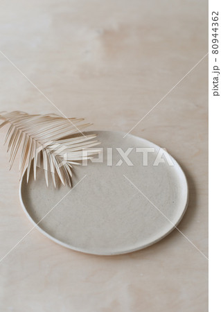 Ceramic plate on a wooden table top view. minimalist handmade ceramic tableware and pottery Ceramic plate on a wooden table top view. minimalist handmade ceramic tableware and pottery 80944362