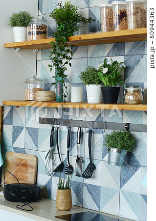 kitchen closeup fragment with pot plants, utensils, peas and beans in container 80944363