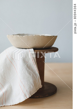 Ceramic bowl on a wooden table top view. Handmade ceramic tableware and pottery Ceramic bowl on a wooden table top view. Handmade ceramic tableware and pottery 80944364