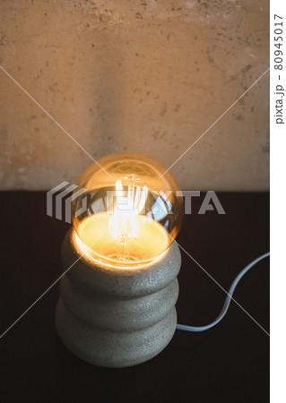 Stylish burning night lamp on table indoors. Light electric for interior home. Stylish burning night lamp on table indoors. Light electric for interior home. 80945017