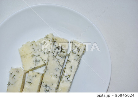 White cheese with blue mold on a white plate 80945024