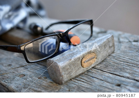 Hammer screwdriver tools and glasses on the board 80945187