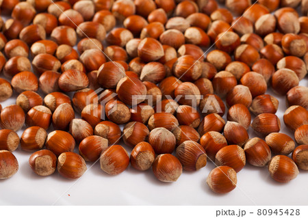 Hazelnuts on white surface Hazelnuts on white surface 80945428