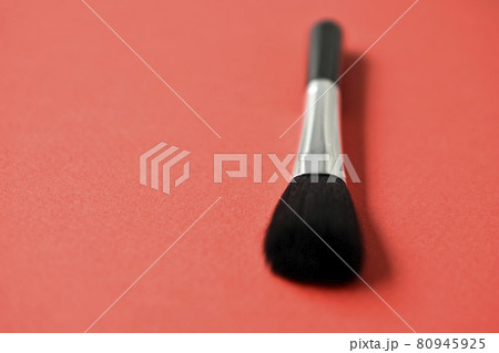 Brush for cleaning optics on a red background 80945925