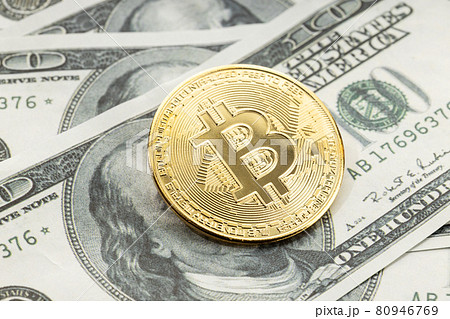 Bitcoin coin on dollar banknotes. Cryptocurrency on US dollar bills 80946769