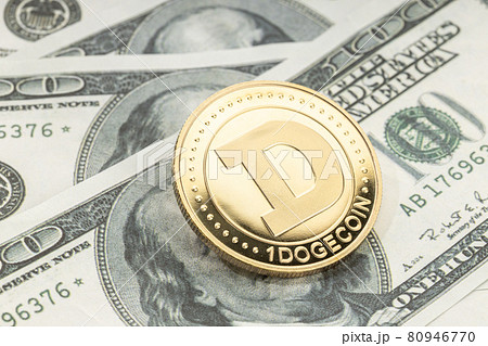 Dogecoin coin on dollar banknotes. Cryptocurrency on US dollar bills 80946770