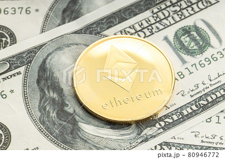 Ethereum coin on dollar banknotes. Cryptocurrency on US dollar bills 80946772