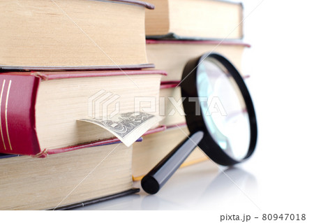 Old books with a loupe on white background. Isolated. Old books with a loupe on white background. Isolated. 80947018