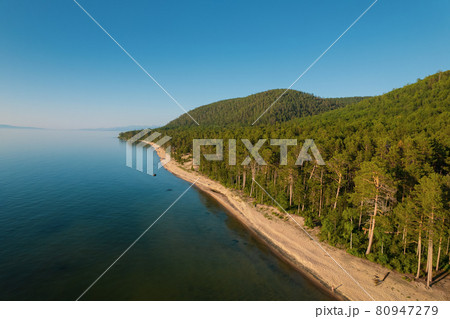 Summertime imagery of Lake Baikal is a rift lake located in southern Siberia, Russia Baikal lake summer landscape view from a cliff near Grandma's Bay. Drone's Eye View. 80947279