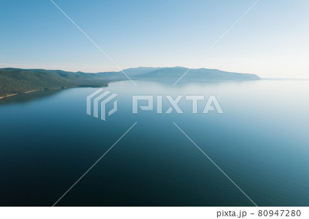 Summertime imagery of Lake Baikal is a rift lake located in southern Siberia, Russia Baikal lake summer landscape view from a cliff near Grandma's Bay. Drone's Eye View. Summertime imagery of Lake Baikal is a rift lake located in southern Siberia, Russia Baikal lake summer landscape view from a cliff near Grandma's Bay. Drone's Eye View. 80947280