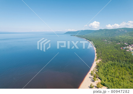 Summertime imagery of Lake Baikal is a rift lake located in southern Siberia, Russia Baikal lake summer landscape view from a cliff near Grandma's Bay. Drone's Eye View. 80947282