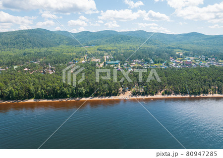 Summertime imagery of Lake Baikal is a rift lake located in southern Siberia, Russia Baikal lake summer landscape view from a cliff near Grandma's Bay. Drone's Eye View. 80947285