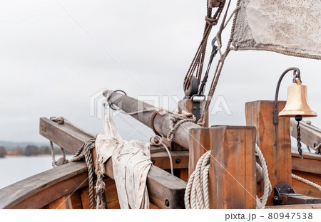Wooden old ship in vintage style with all sails set in misty lake. Moody background. Wooden old ship in vintage style with all sails set in misty lake. Moody background. 80947538
