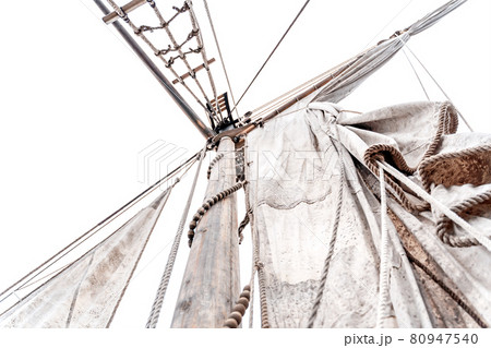 Wooden old ship in vintage style with all sails set in misty lake. Moody background. Wooden old ship in vintage style with all sails set in misty lake. Moody background. 80947540