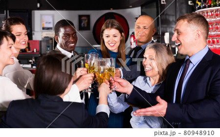 International group of businesspeople toasting with champagne, having fun at office party in nightclub International group of businesspeople toasting with champagne, having fun at office party in nightclub 80948910