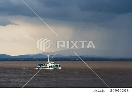 Landscape with a large river, which floats boat. Amur River. Khabarovsk Region, Russia. 80949298