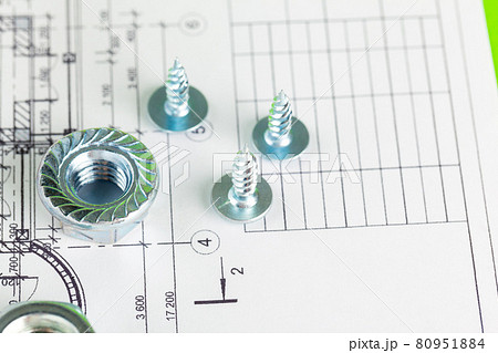 Nuts and bolts close-up over house plan Nuts and bolts close-up over house plan 80951884