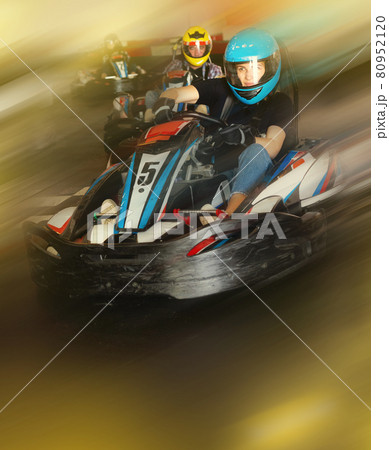 Man and women competing on racing cars Man and women competing on racing cars 80952120