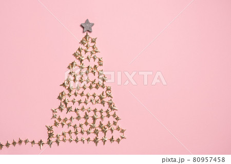 Flat lay with golden christmas tree with star on pink background Flat lay with golden christmas tree with star on pink background 80957458