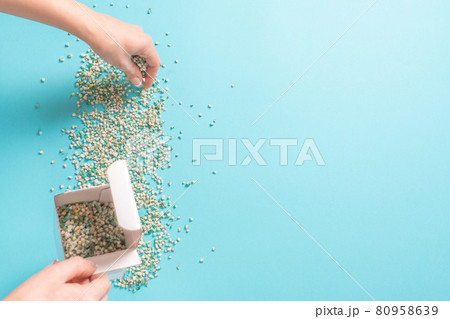 Woman Decorating backround with gypsophila flowers with copy space on light green background, flat lay 80958639
