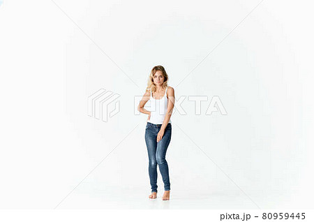 cheerful woman woman in jeans barefoot dancing on the floor 80959445