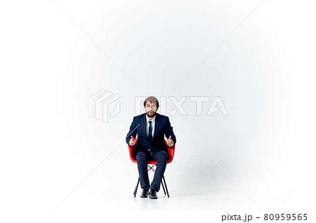 business man in suit sitting on red chair emotions office fun 80959565