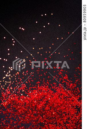 Red glitter on black paper background with copy space, flat lay Red glitter on black paper background with copy space, flat lay 80959903