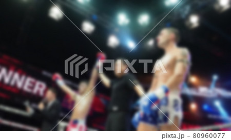 Thai Kick boxing. Blurred images of Muay Thai. Martial Art Kickboxing. Local and foriegn boxer are fighting on the ring at indoor stadium stage. Muaythai is sport competition for traveller sightseeing 80960077