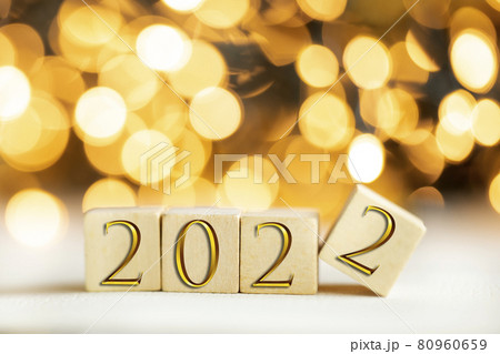 The year 2022 written on wooden cubes in gold luxury letters with shiny bokeh background, New Year celebration concept glitter The year 2022 written on wooden cubes in gold luxury letters with shiny bokeh background, New Year celebration concept glitter 80960659