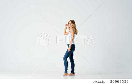 woman in jeans barefoot studio positive energy model woman in jeans barefoot studio positive energy model 80962535