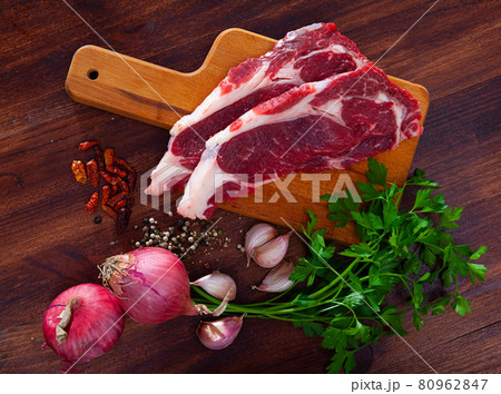 Raw beef fillet with onion and pepper ready for cooking on table Raw beef fillet with onion and pepper ready for cooking on table 80962847