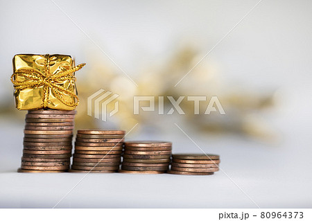 Coin climbing stairs with Christmas Holiday present, sparkling and shiny background, Finance,saving concept stacks of coins Coin climbing stairs with Christmas Holiday present, sparkling and shiny background, Finance,saving concept stacks of coins 80964373
