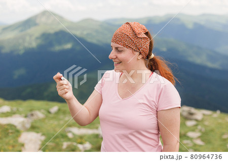 Happy Woman holding a compass in hand on nature background, ready to travel, keep calm. Tourism, traveling, hiking and healthy lifestyle concept. 80964736