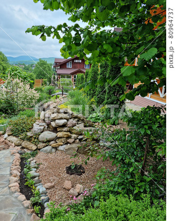 landscape design in cottage village. wooden houses for rest in the mountains. 80964737