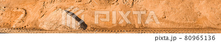 A large pile of sand in storage on industrial warehouse at a construction site A large pile of sand in storage on industrial warehouse at a construction site 80965136