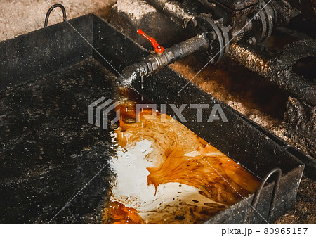Drain oil-condensate mixture from an air compressor at an industrial plant Drain oil-condensate mixture from an air compressor at an industrial plant 80965157