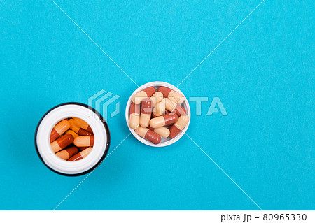 Pharmaceutical Industry and Medicinal Products - Colored Pills on Blue Table 80965330