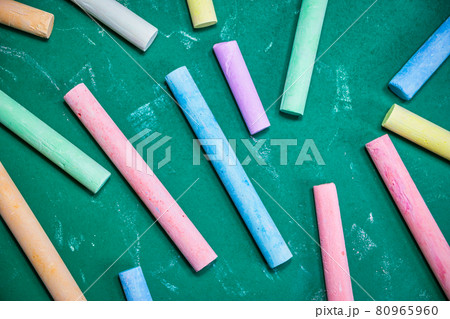 Multicolored chalks on a green chalkboard Multicolored chalks on a green chalkboard 80965960