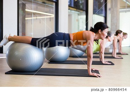 Women lying on gymnastic ball. Fitness workuot in gym 80966454