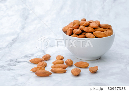 Almonds nuts on marble background.. Almonds nuts on marble background.. 80967388