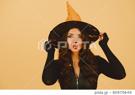 Young woman in haloween costume pose on color background 80970649