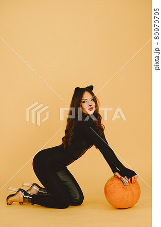 Woman with cat makeup and ears on color background Woman with cat makeup and ears on color background 80970705