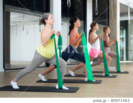 Women stretching with resistance bands 80971463