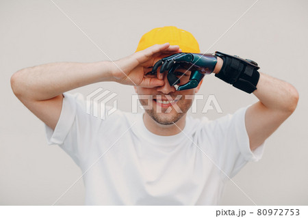 Young disabled man with artificial prosthetic hand in casual clothes. Young disabled man with artificial prosthetic hand in casual clothes. 80972753
