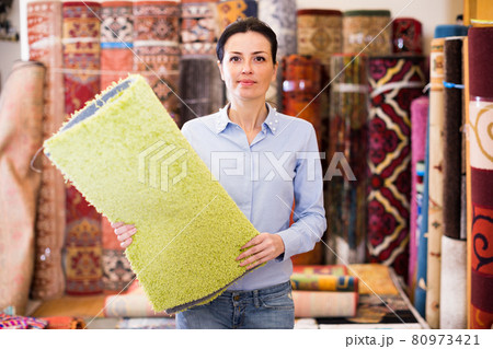 Female touching and choosing carpets 80973421