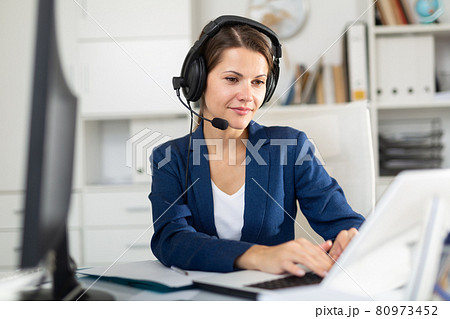 Woman call center operator using laptop in office 80973452