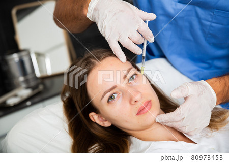 Woman receiving rejuvenating facial injections in clinic Woman receiving rejuvenating facial injections in clinic 80973453