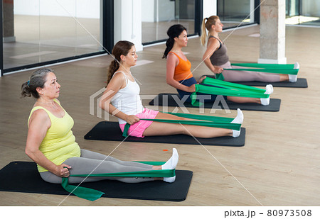 Aerobics pilates women with rubber bands 80973508