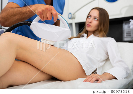 Woman getting IPL therapy procedure on legs Woman getting IPL therapy procedure on legs 80973518